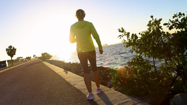 Sunrise female jogging and exercising outdoors Tampa Florida 