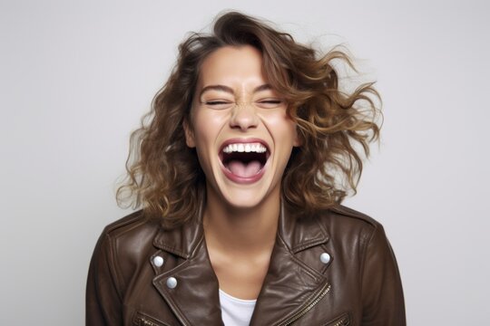 Closeup Portrait Of A Laughing Young Woman In Brown Leather Jacket.