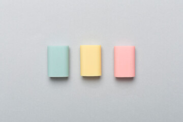 Colorful eraser on color backgroung, top view