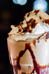 Creamy Milkshake with Chocolate Drizzle and Whipped Cream at a Bar Counter