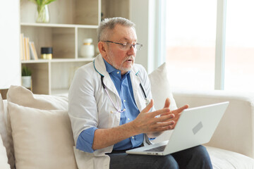 Fototapeta na wymiar Senior man doctor with laptop talk on video call have consultation with patient. Professional senior mature healthcare expert examining patient online. Medicine healthcare medical checkup