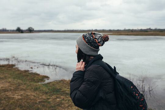 Woman walking near the frozen lake 