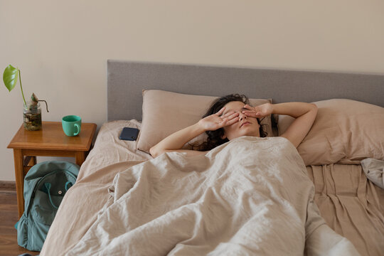 woman rubbing her face
