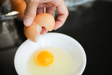 Whole eggs represent vitality and potential, cracked eggs symbolize vulnerability, while yolk represents nourishment. Contextualized against health concerns and rising inflation