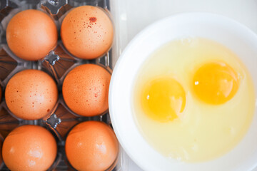 Whole eggs represent vitality and potential, cracked eggs symbolize vulnerability, while yolk represents nourishment. Contextualized against health concerns and rising inflation