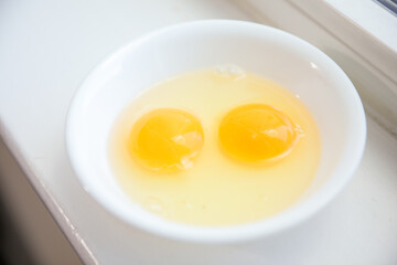 Whole eggs represent vitality and potential, cracked eggs symbolize vulnerability, while yolk represents nourishment. Contextualized against health concerns and rising inflation