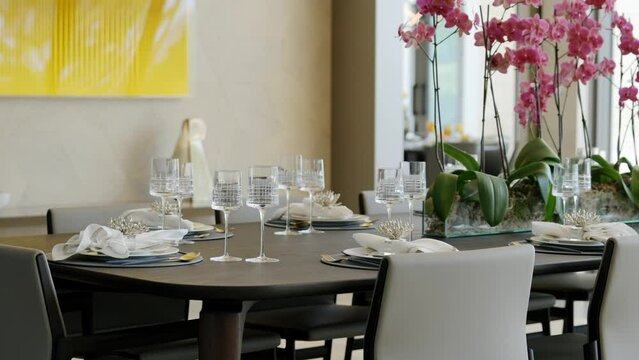 Wooden dining table served with fancy cutlery, textile napkins and shiny glasses. Blooming flowers orchid as decoration in middle of set. Stylish interior details