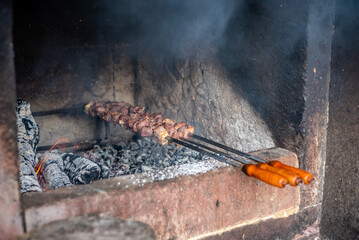 Typical Madeira skewers cooking on a grill 