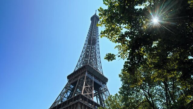 Historical landmark of the World famous symbol of Paris, France. View of the Tower's detailed wrought-iron structure as the camera moves from the base of the tower to the observation deck at the top.