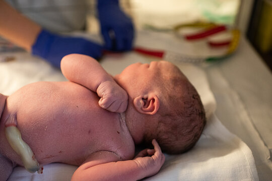undressed newborn baby in hospital