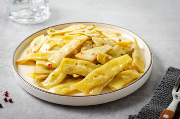 Cooked Yellow Beans, Long Beans in a Plate over Light Grey Background, Tasty Vegetarian Meal