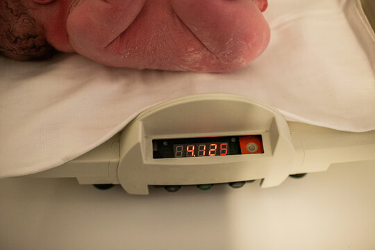 Newborn baby on scale in hospital