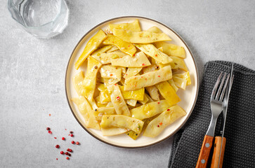 Cooked Yellow Beans, Long Beans in a Plate over Light Grey Background, Tasty Vegetarian Meal