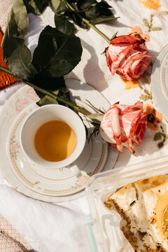 Aesthetic photo of one teacups on flowered cloth.