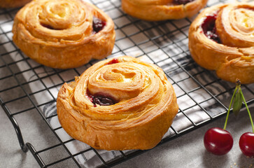 Freshly Baked Puff Pastry with Cherry on Bright Grey Background