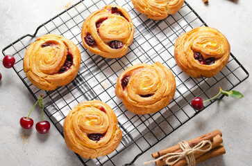 Freshly Baked Puff Pastry with Cherry on Bright Grey Background