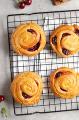 Freshly Baked Puff Pastry with Cherry on Bright Grey Background