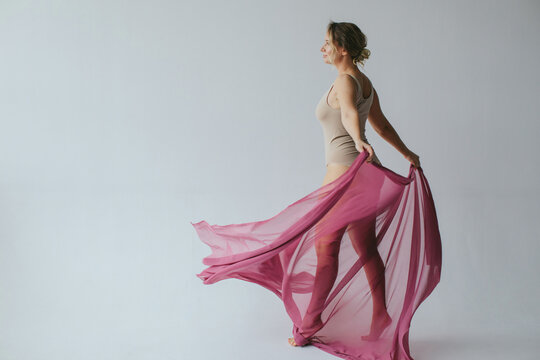 Woman dancing with pink fabric 