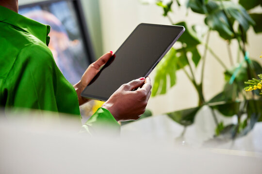 Cropped image of businesswoman holding tablet with black screen