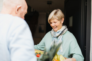 Volunteer bringing food to a senior