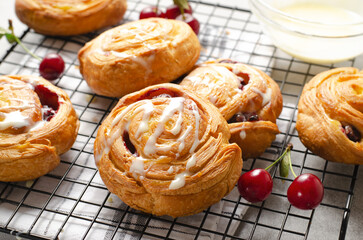 Freshly Baked Puff Pastry with Cherry and Sweet Glaze on Bright Grey Background