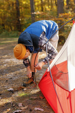 Camper setting up tent activity campsite