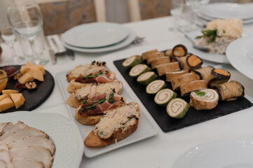 Canapes with ham, cheese, cucumber and olives. Festive buffet