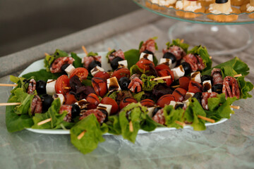Canapes with ham, cheese, cucumber and olives. Festive buffet
