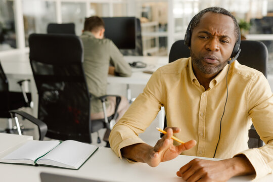 African American. Manager at work. Headset. Conversation. Office