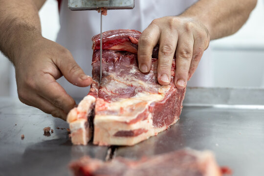 Chunk of meat being sliced at butchery before selling