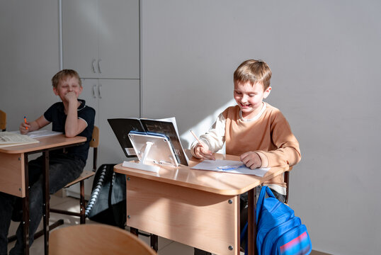 new student in a classroom sitting at a desk