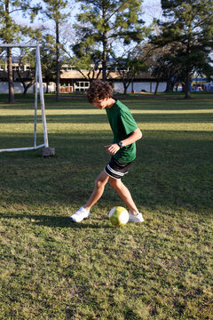Soccer player practicing dribbling on the field