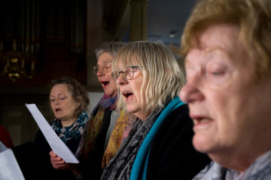 Women of choir practicing
