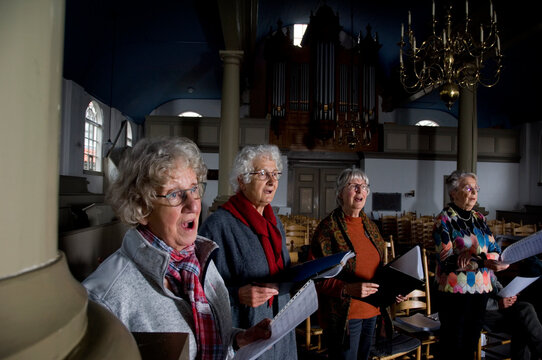 Women of choir practicing
