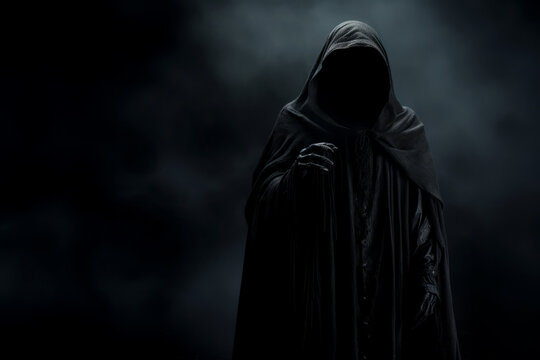 Creepy halloween grim reaper figure wearing a black rope against a dark background