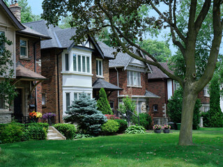 Street of traditional detached houses with front lawns