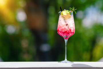 a drink with a straw and ice in a green fuzzy setting 