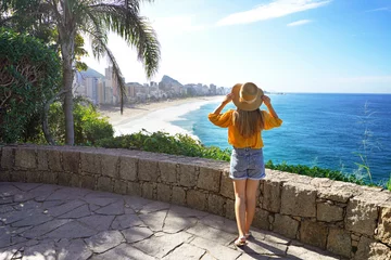 Photo sur Plexiglas Rio de Janeiro Holidays in Rio de Janeiro. Full length of beautiful fashion girl enjoying view of Rio de Janeiro beaches of Leblon and Ipanema. Summer vacation in Brazil.