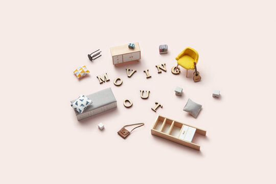 Miniature apartment furniture with Moving Out letters.