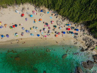 aerial view from the drone of Michelino beach near Tropea in Calabria. You notice the crystal clear Caribbean sea with bathers and umbrellas. the image gives a sense of peace and relaxation