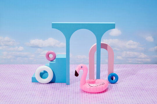 Pink flamingo float in front of pastel stone elements.
