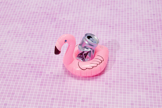 Pink flamingo float with crumpled tin can.