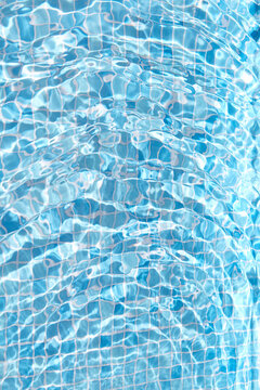 Simple blue-tiled swimming pool with water background.