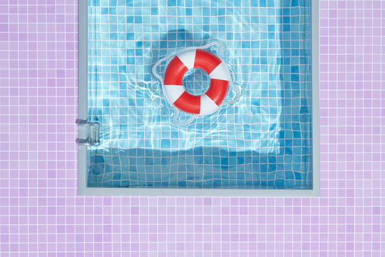 Red and white inflatable ring in water of blue pool.