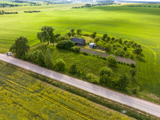 Obraz premium panoramic aerial view of eco village with wooden houses, gravel road, gardens and orchards