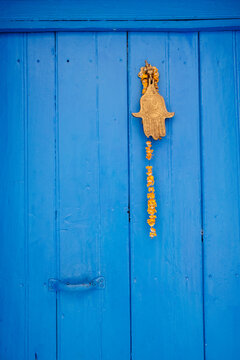 Fatima hand knocker on blue door