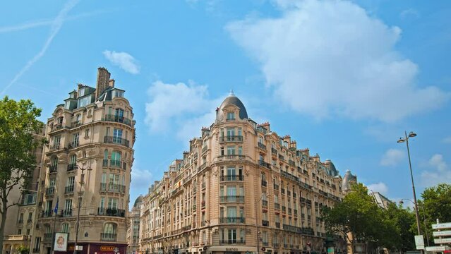 Cinematic view of French buildings in Paris. Historical old landmarks of Paris, architectural buildings. Typical Parisian building with balconies and windows in France.