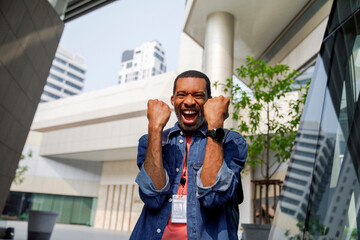 Ecstatic male employee celebrating success outdoors in city