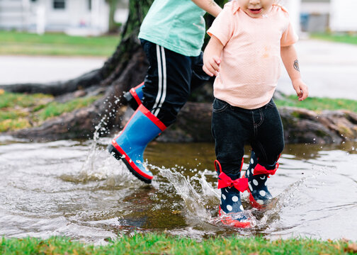 Kids jump in puddle
