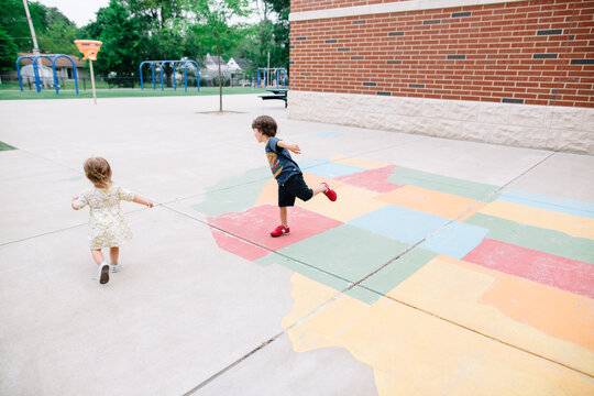 Children run around on map of united states